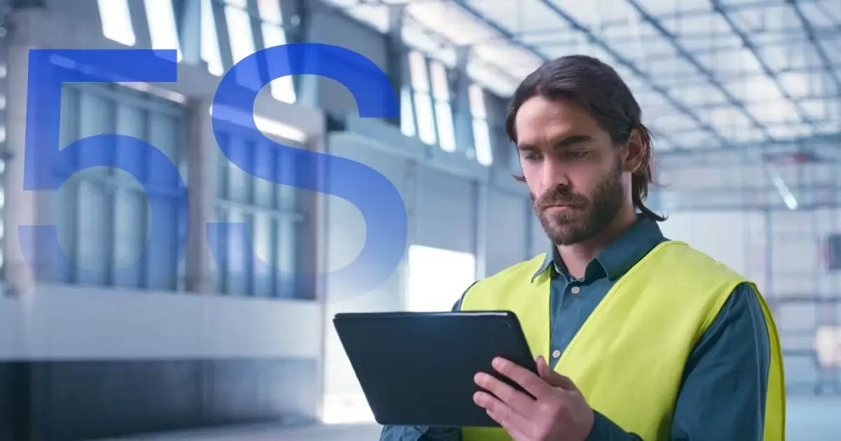 a male worker reading the 5S lean manufacturing principle on an ipad before going to work