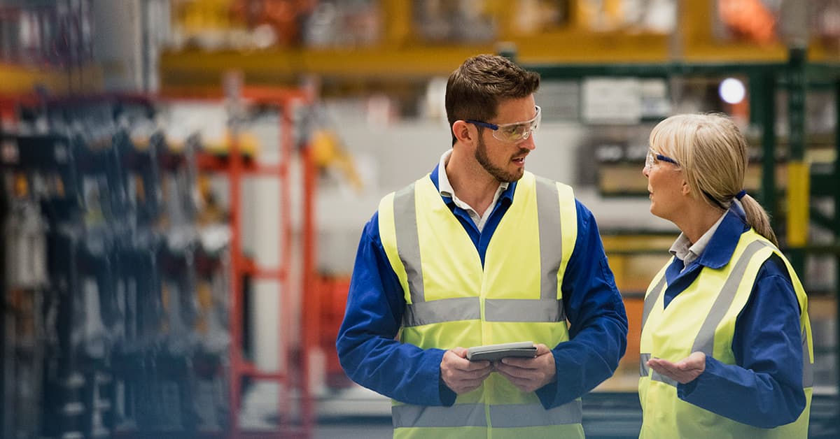 Quality manager and colleague perform a plant floor audit with a mobile device