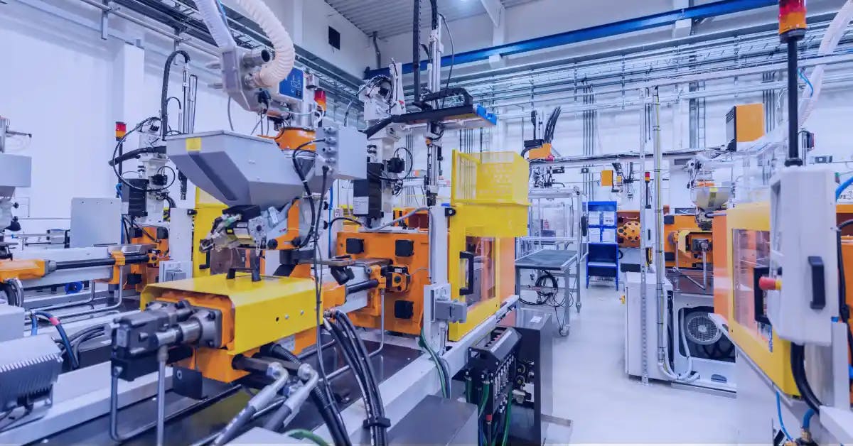 A modern manufacturing plant floor with automated machinery, showcasing operational efficiency indicative of optimized OEE KPIs